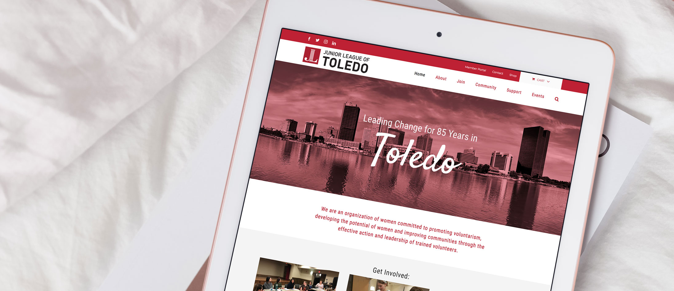 Overhead photo of the new Junior League of Toledo WordPress website loaded on a white tablet