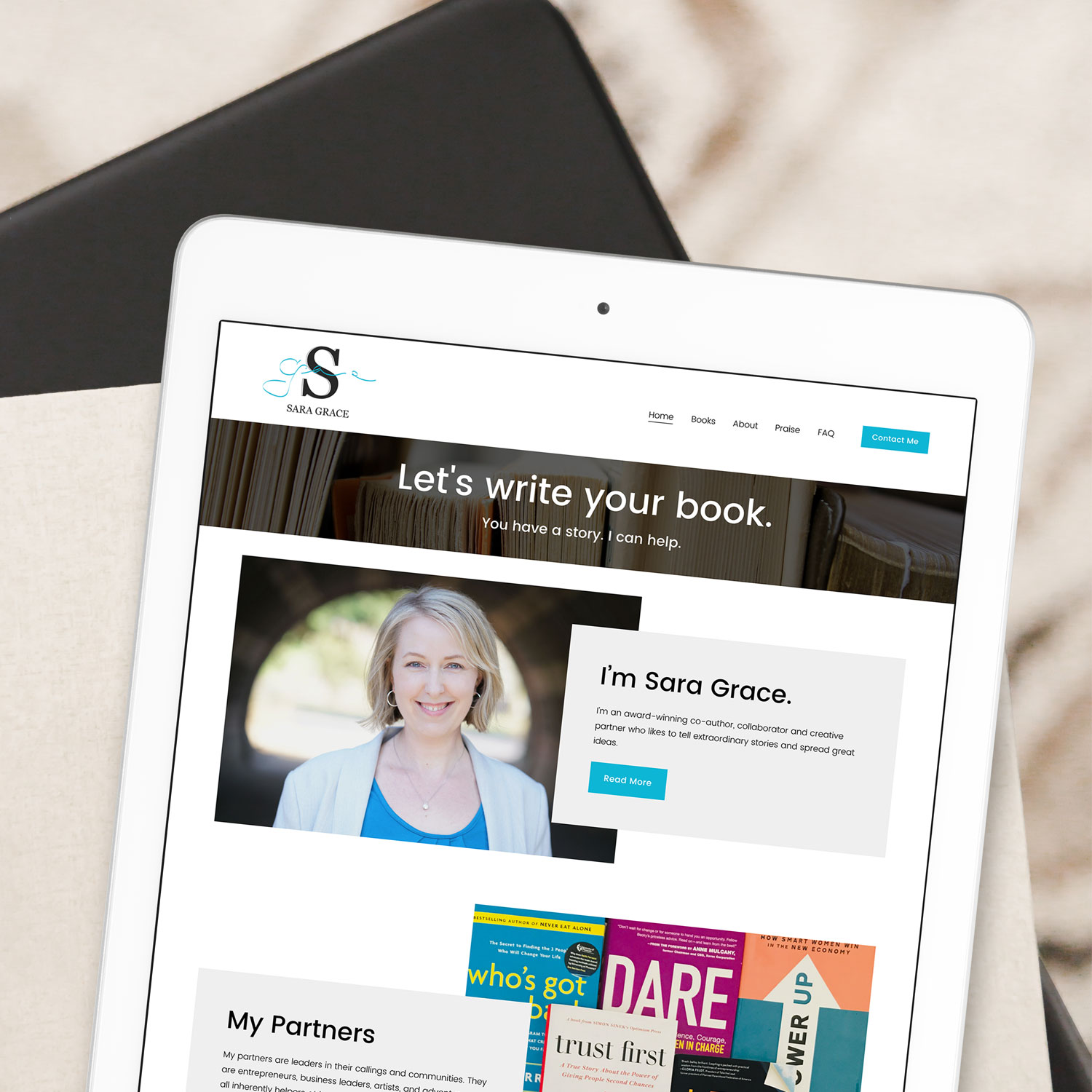 Photo of Sara Grace Editorial's new Squarespace website loaded on a white tablet